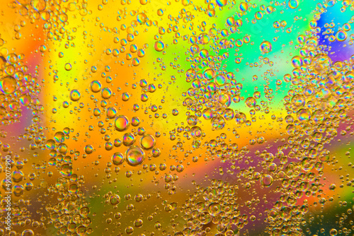 Bubbles in oil in water on a rainbow abstract macro background.