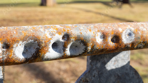 Bullet marks on the steel formed spots and holes deepened.