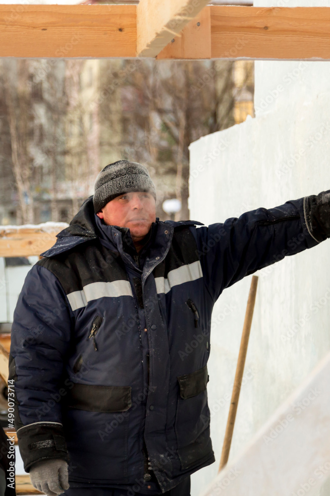 Portrait of an installer at the construction of an ice town Portrait of an installer at the construction of an ice town