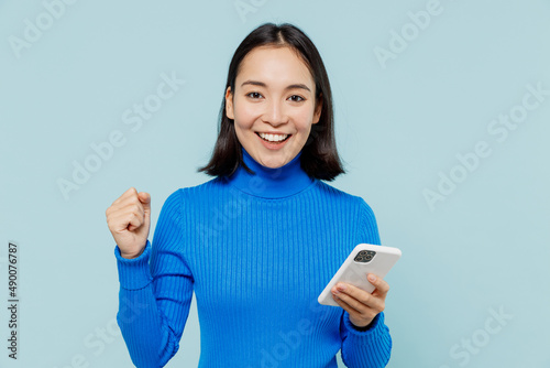 Tableau sur toile Fun young woman of Asian ethnicity 20s years old wear blue shirt hold in hand us