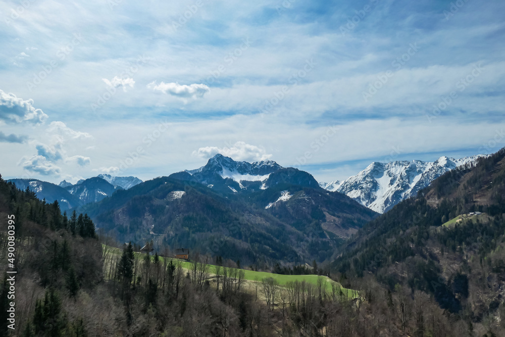 Scenic view of snow capped mountain peaks of Karawanks near Sinacher Gupf in Carinthia, Austria. Mount Wertatscha and Hochstuhl (Stol) is visible in early spring. Hills in Rosental on sunny day. Hike