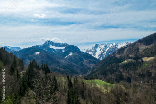 Scenic view of snow capped mountain peaks of Karawanks near Sinacher Gupf in Carinthia, Austria. Mount Wertatscha and Hochstuhl (Stol) is visible in early spring. Hills in Rosental on sunny day. Hike