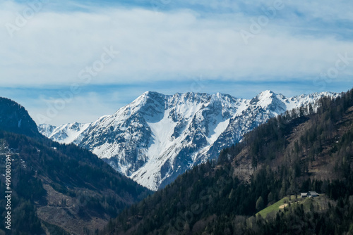 Scenic view of snow capped mountain peaks of Karawanks near Sinacher Gupf in Carinthia  Austria. Mount Wertatscha and Hochstuhl  Stol  is visible in early spring. Hills in Rosental on sunny day. Hike
