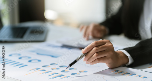Financial businessman calculating corporate income tax data And analyzing charts of financial stocks that are in good condition with growth and progress, Investment in finance and accounting. © PaeGAG