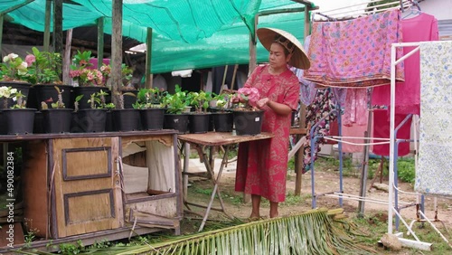 Asian woman with Vietnamese straw making small business