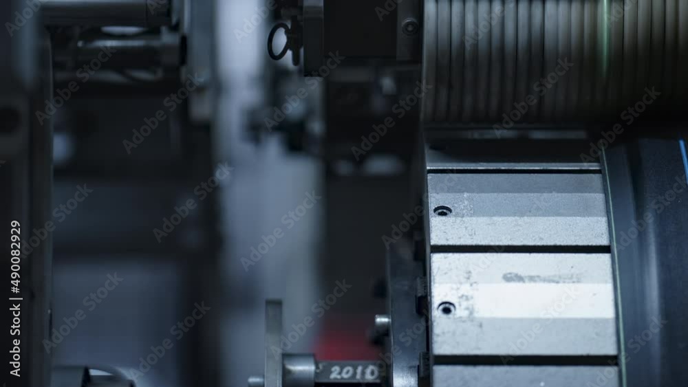 Detailed rubber tyre tape on mechanical automated machine rotating in plant Detailed rubber tyre tape on mechanical automated machine rotating in plant