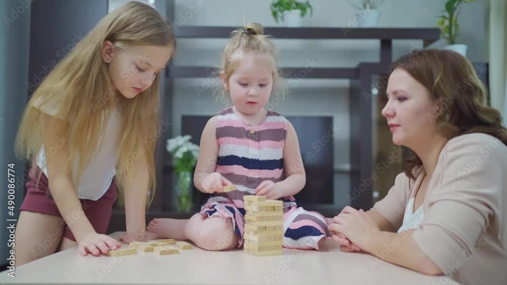 mom and daughters play blocks. educational and interesting games for family. mom and daughters play blocks. educational and interesting games for family.