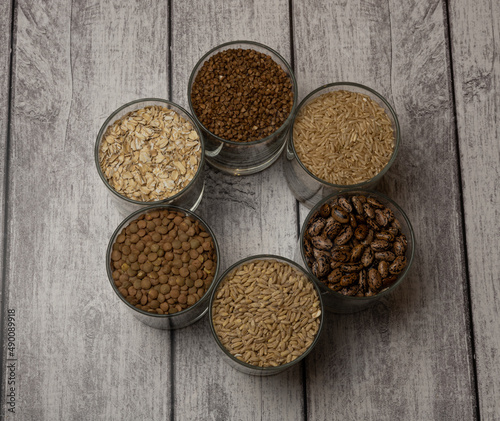 cereals in a glass standing on the table, buckwheat, rice, barley, beans, oatmeal, lentils