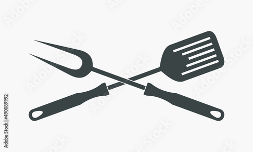 BBQ or grill tools graphic icon. Crossed barbecue fork and spatula sign isolated on white background. Symbol in flat design. Vector illustration 