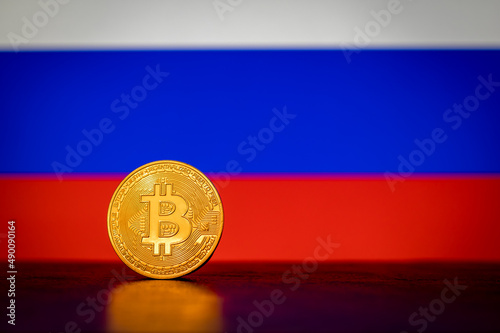 Bitcoin cryptocurrency with Russian flag in the background