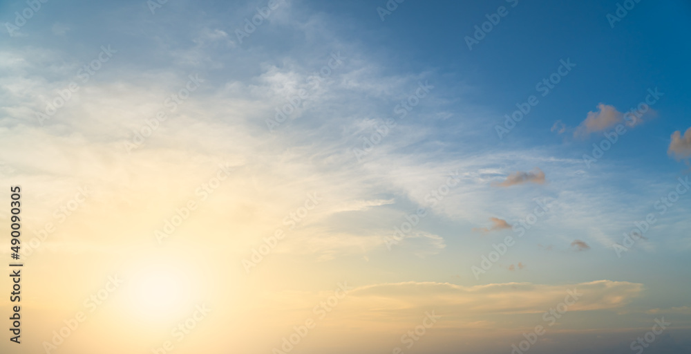 Sunset sky in the evening with golden sunrise and blue clouds