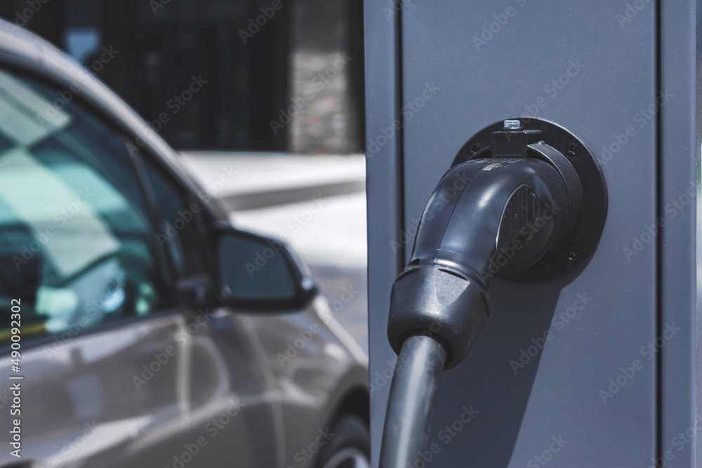 Close-up, power supply for the station, charging electric vehicles. On the background of the car. Close-up, power supply for the station, charging electric vehicles. On the background of the car.