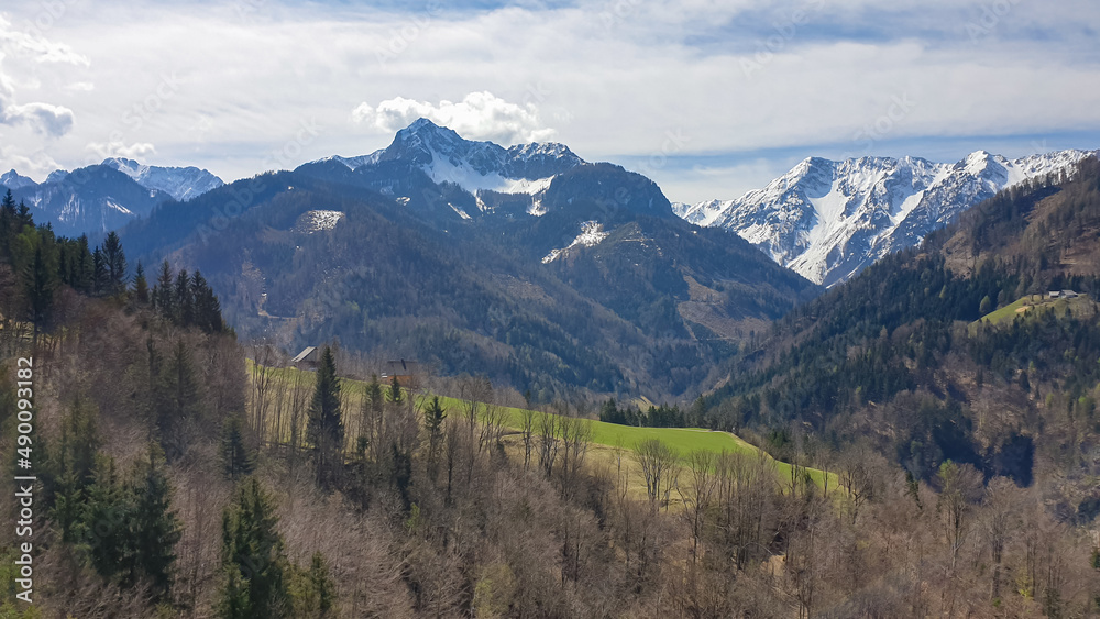 Scenic view of snow capped mountain peaks of Karawanks near Sinacher Gupf in Carinthia, Austria. Mount Wertatscha and Hochstuhl (Stol) is visible in early spring. Hills in Rosental on sunny day. Hike