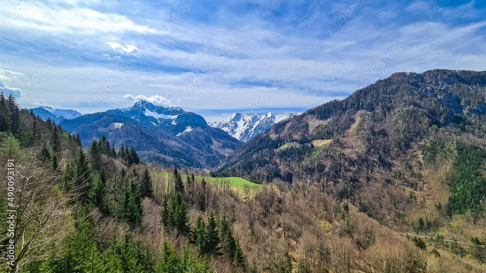 Scenic view of snow capped mountain peaks of Karawanks near Sinacher Gupf in Carinthia, Austria. Mount Wertatscha and Hochstuhl (Stol) is visible in early spring. Hills in Rosental on sunny day. Hike