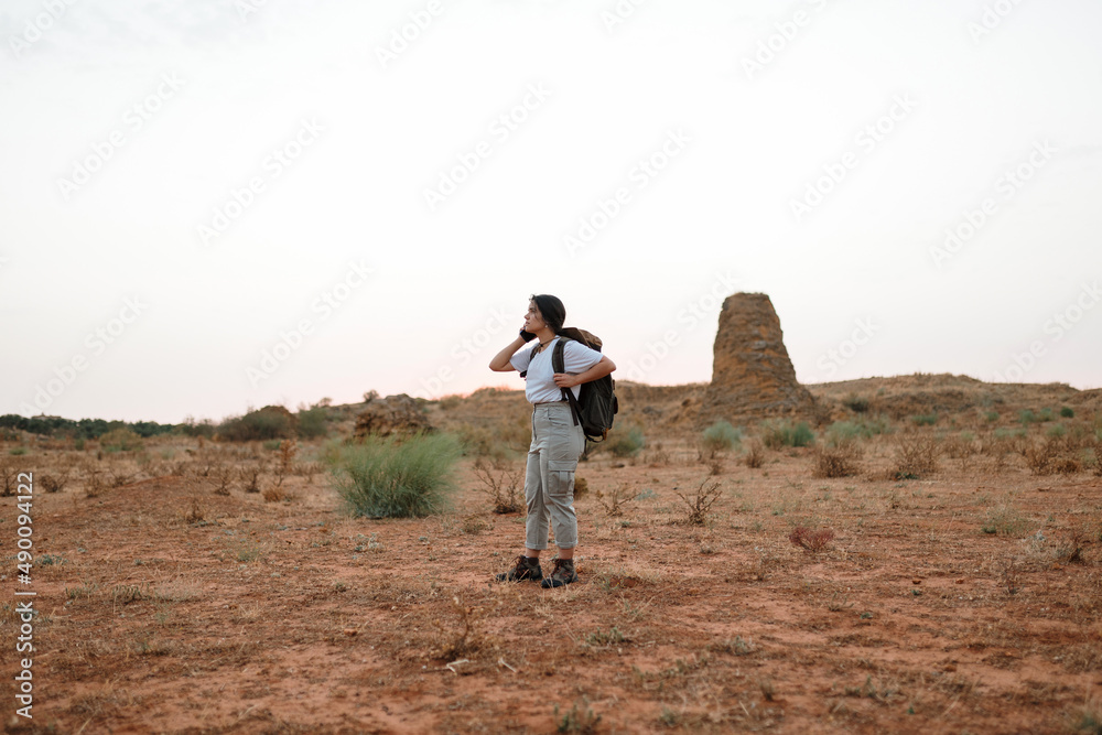 Woman talking on smartphone in desert Woman talking on smartphone in desert