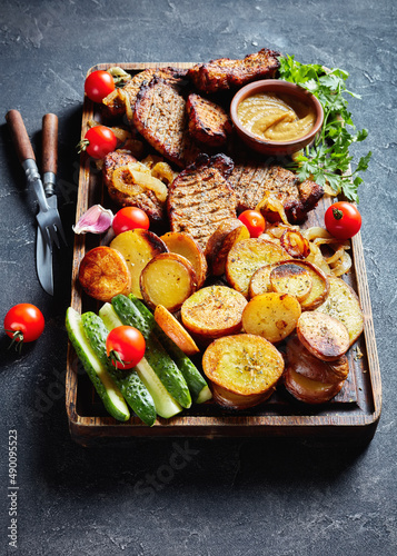 grilled pork cutlets with roasted potato, close-up