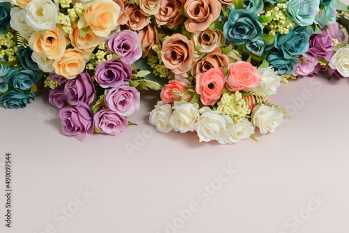 spring flowers, different colors roses on a pale pink background, free space for text, elegant spring composition, flower frame © Ritk