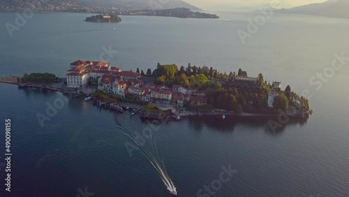 Boat floats on the lake from the island at sunset. Maggiore Italy. High quality 4k footage