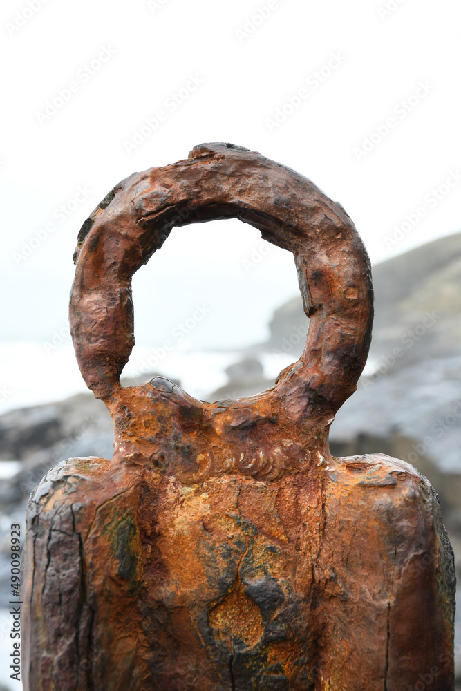 A corroded piece of iron on Tregardock Beach Cornwall A corroded piece of iron on Tregardock Beach Cornwall