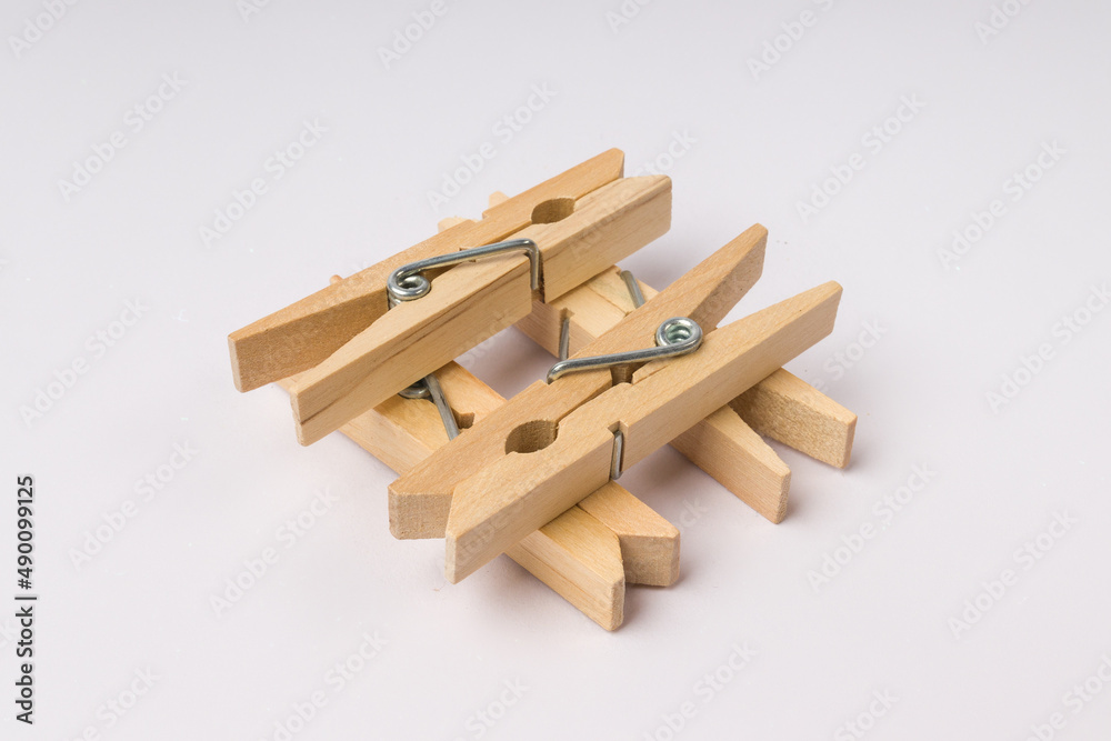 well made of wooden clothespins on a white background well made of wooden clothespins on a white background