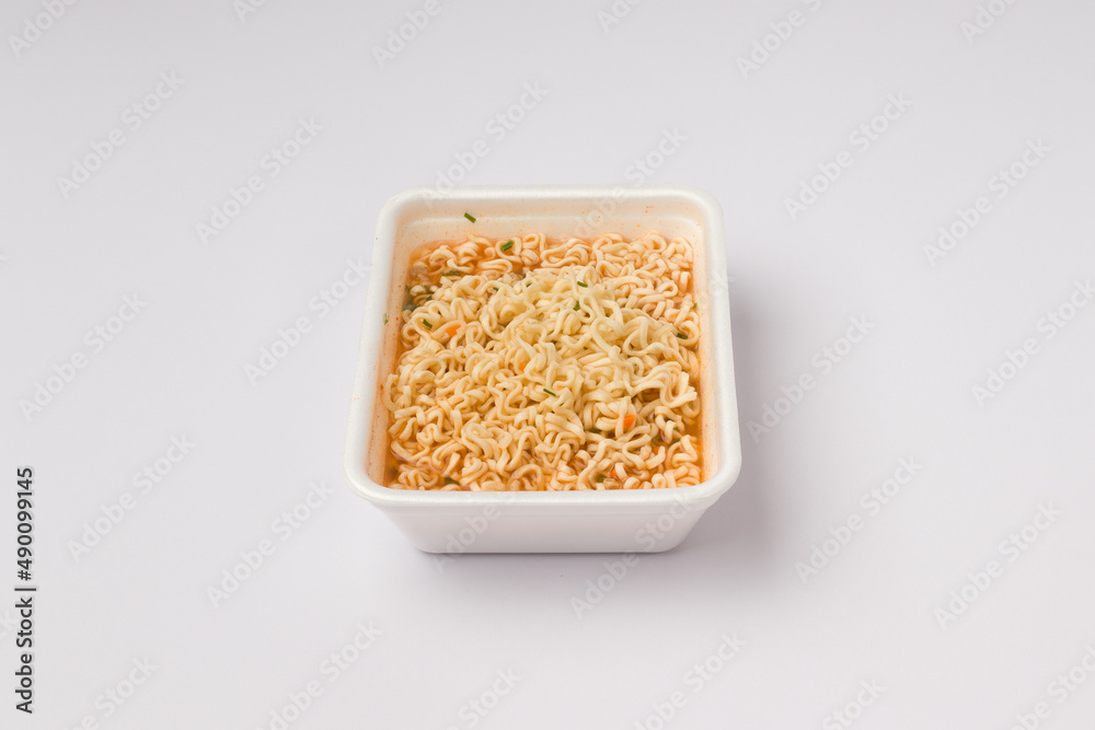 instant noodles with vegetables and spices on a white background. fast food concept instant noodles with vegetables and spices on a white background. fast food concept