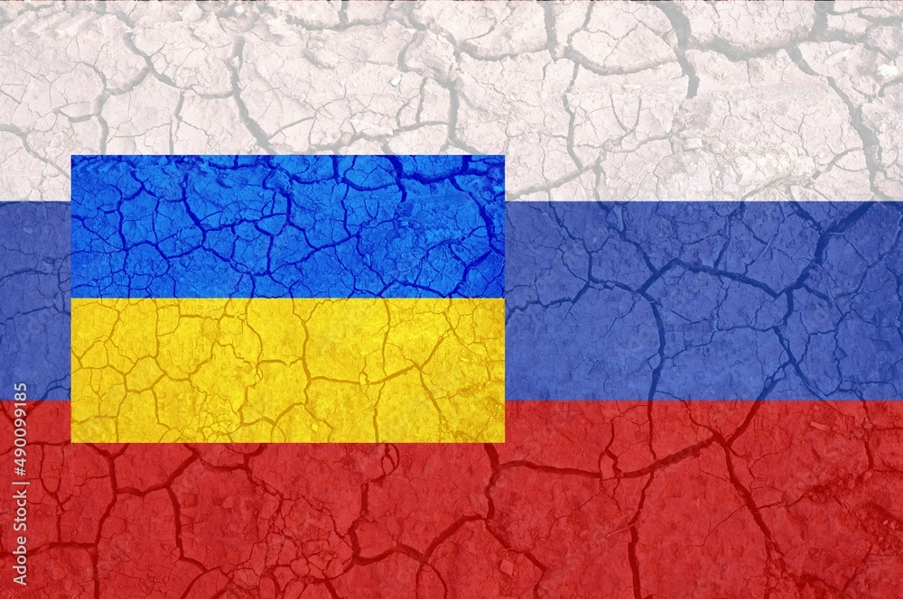 Ukraine and Russia two flags on flagpoles banner on cracked earth background