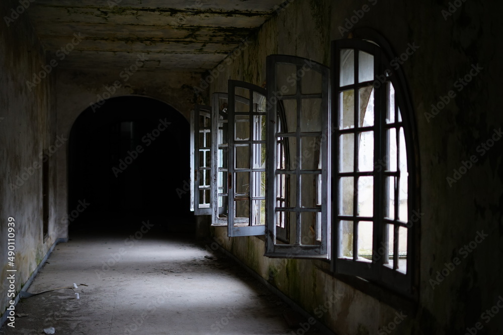 Opened windows in the aisle of an abandoned building Opened windows in the aisle of an abandoned building