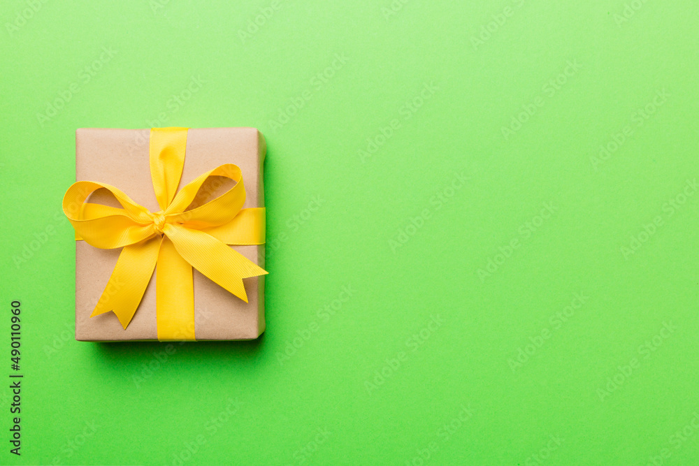 Holiday present box over colored background, top view. Copy space for design Holiday present box over colored background, top view. Copy space for design