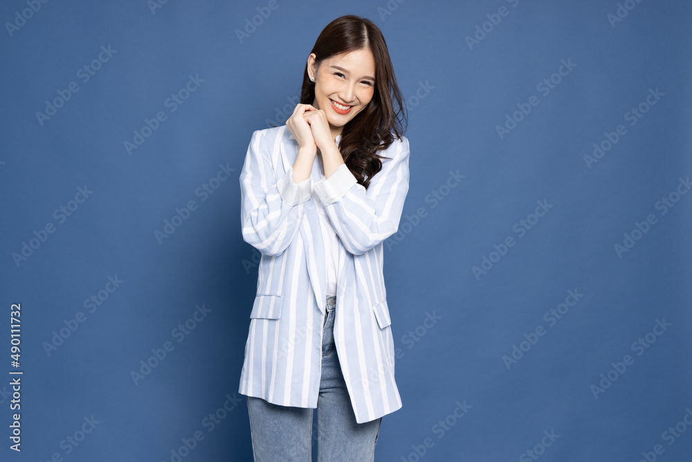 Portrait of Young beautiful Asian businesswoman smiling isolated on blue background, Looking at camera Portrait of Young beautiful Asian businesswoman smiling isolated on blue background, Looking at camera