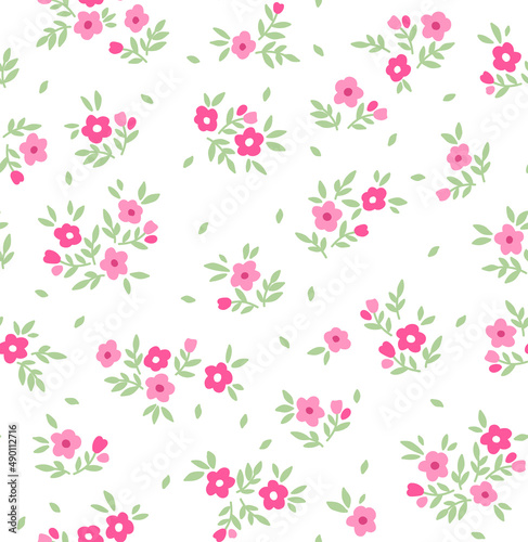 Vintage floral background. Floral pattern with small pink flowers on a white background. Seamless pattern for design and fashion prints. Ditsy style. Stock vector illustration.