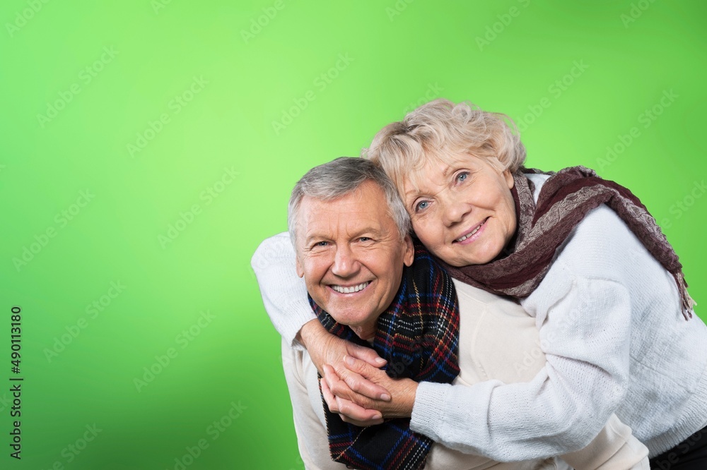 Senior man carrying his wife on his shoulders laughing. Attractive crazy old senior couple Senior man carrying his wife on his shoulders laughing. Attractive crazy old senior couple