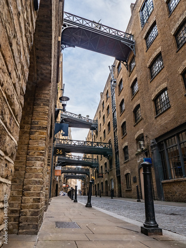 Shad Thames, London. Low, wide angle view of the Victorian architecture of the former industrial area now a gentrified shopping and business district. photo