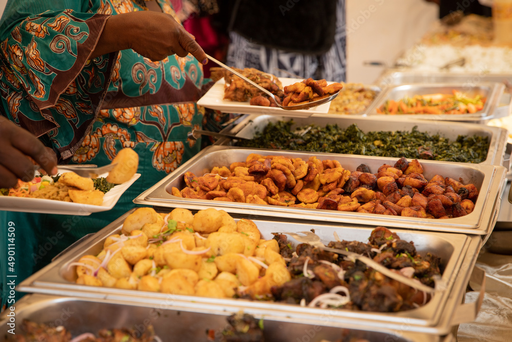 Close-up of African food during a buffet at a party. Fried plantains,  potatoes, meat and vegetables Stock Photo | Adobe Stock