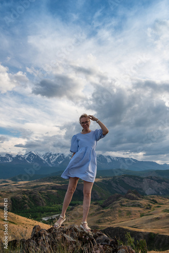 Woman in blue dress in summ...
