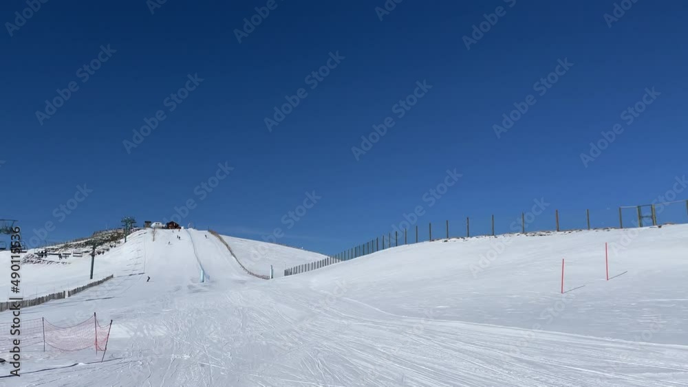 Snowboarder going fast in the straight line from the slope Snowboarder going fast in the straight line from the slope