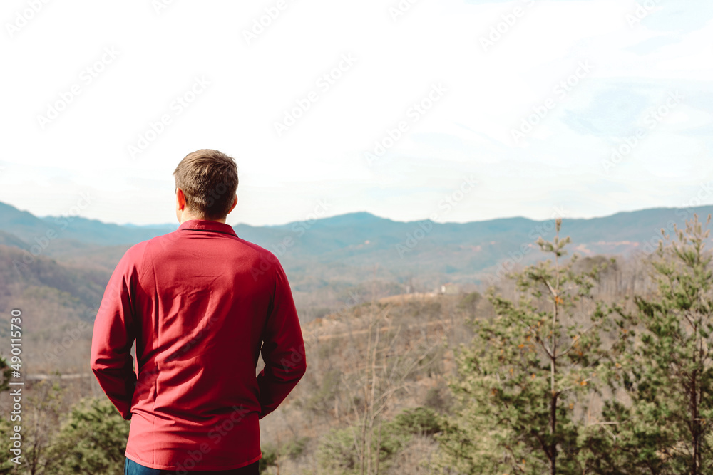 A young man looking over the Smokey Mountains in Tennessee. A young man looking over the Smokey Mountains in Tennessee.