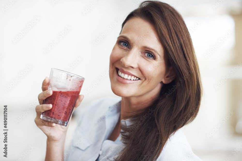 Thats her smoothie smile. Closeup shot of an attractive woman enjoying a fruit smoothie. Thats her smoothie smile. Closeup shot of an attractive woman enjoying a fruit smoothie.
