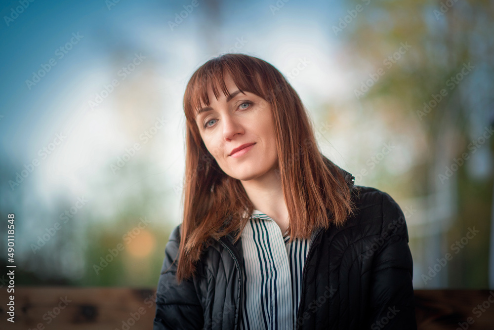 Portrait of a young beautiful girl with dark red hair in a summer park. Portrait of a young beautiful girl with dark red hair in a summer park.