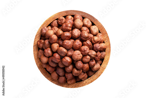 forest nuts peeled in wooden bowl isolated on white background. Vegan food, top view.
