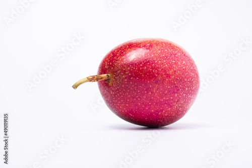 One passion fruit is purple on white background. photo