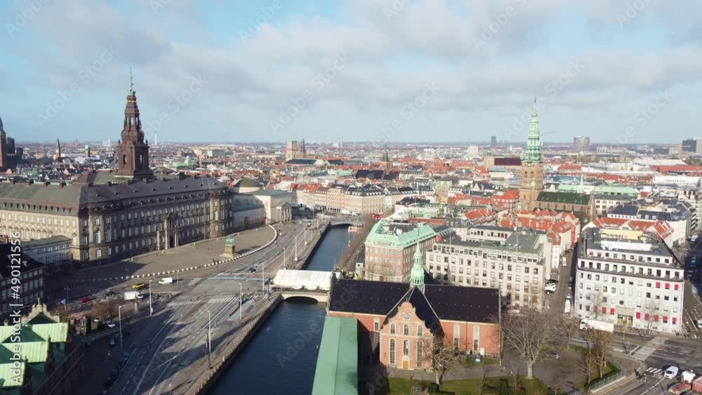 Aerial drone footage of the Copenhagen historic city center in Denmark capital city with the  Christiansborg palace and the Borsen historic building. Shot with a forward motion. 