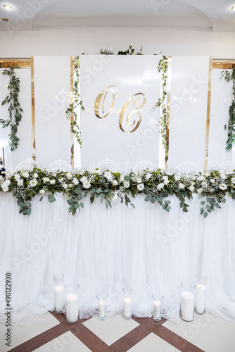 Beautiful wedding arch of flowers for the newlyweds. Decoration on a holiday