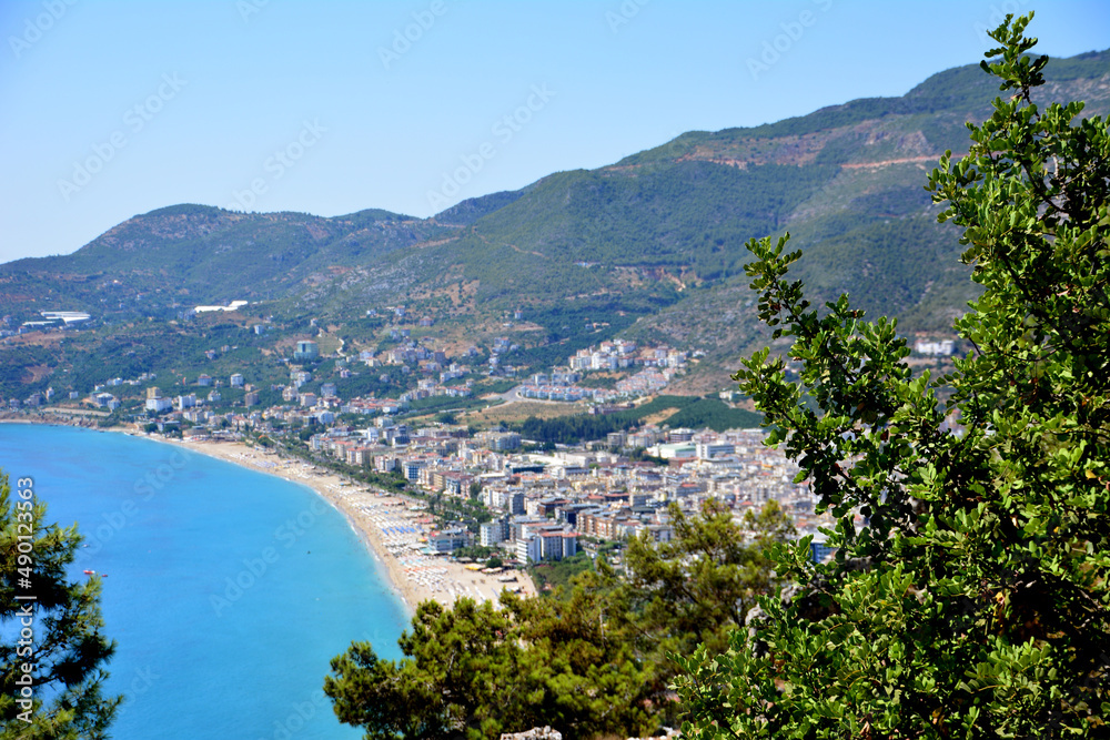 Fototapeta premium cleopatra beach with sandline and blue sea, view from top on harbor and surrounding mountains