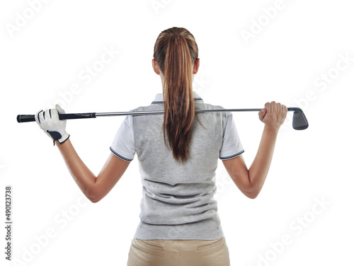 In command of her club. Studio shot of a young golfer holding a golf club behind her back isolated on white. © Stigur/peopleimages.com