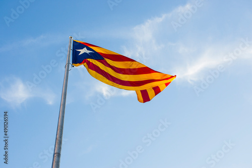 Photography large flag of catalonia waving with iron mast