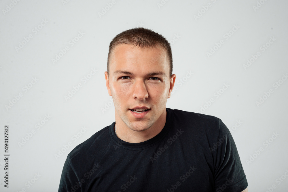 Portrait of a serious casual man standing on a white background Portrait of a serious casual man standing on a white background