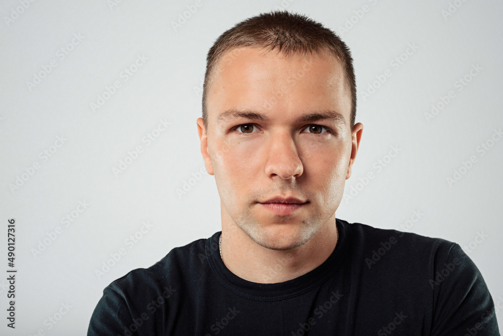 Portrait of a serious casual man standing on a white background Portrait of a serious casual man standing on a white background