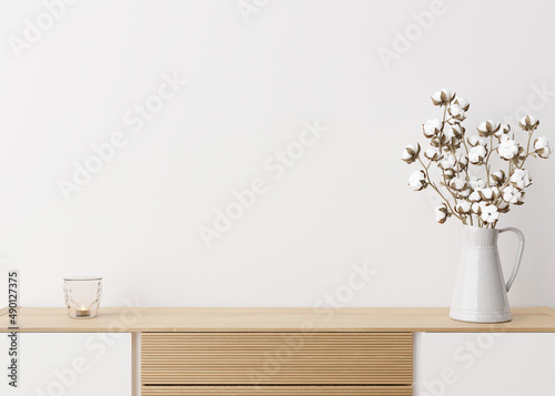 Empty white wall. Mock up interior in contemporary style. Close up view. Free space, copy space for your picture, text, or another design. Sideboard, cotton plant. 3D rendering.