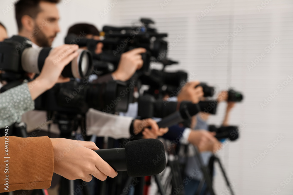 Group of journalists with cameras waiting for official person indoors, closeup Group of journalists with cameras waiting for official person indoors, closeup