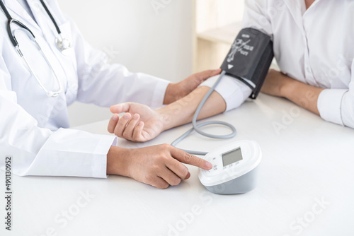 Doctor using a measuring blood pressure checking patient with examining, presenting results symptom and recommend treatment method, Healthcare and medical concept